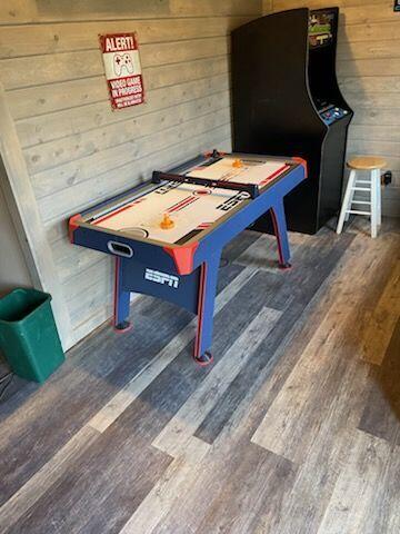 game room with wooden walls and hardwood / wood-style floors