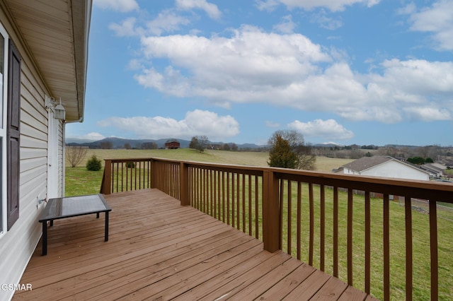 deck featuring a yard and a rural view