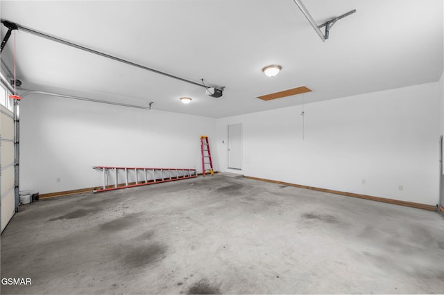 garage featuring a garage door opener and baseboards