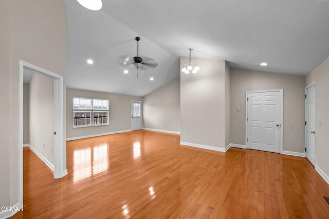 unfurnished living room with light wood-type flooring, high vaulted ceiling, ceiling fan with notable chandelier, recessed lighting, and baseboards