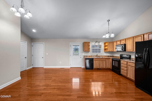 kitchen with light wood finished floors, baseboards, a chandelier, black appliances, and open shelves