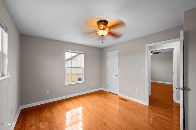 unfurnished bedroom with visible vents, baseboards, light wood-type flooring, and ceiling fan