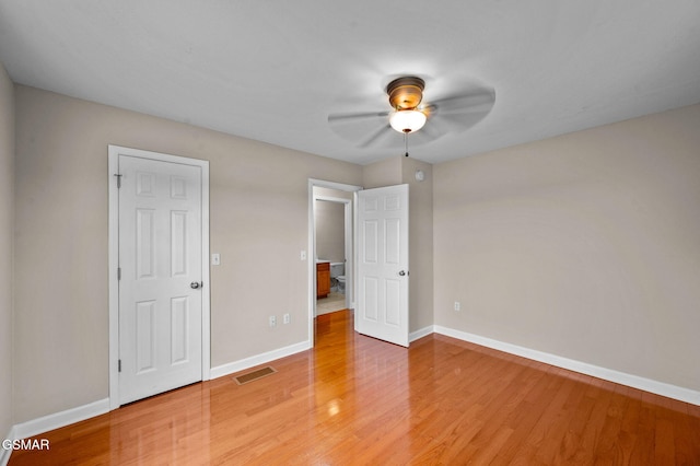 unfurnished bedroom with light wood-type flooring, visible vents, baseboards, and ceiling fan