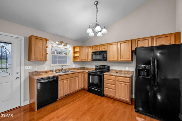 kitchen featuring black appliances, light wood-style flooring, a sink, open shelves, and a chandelier