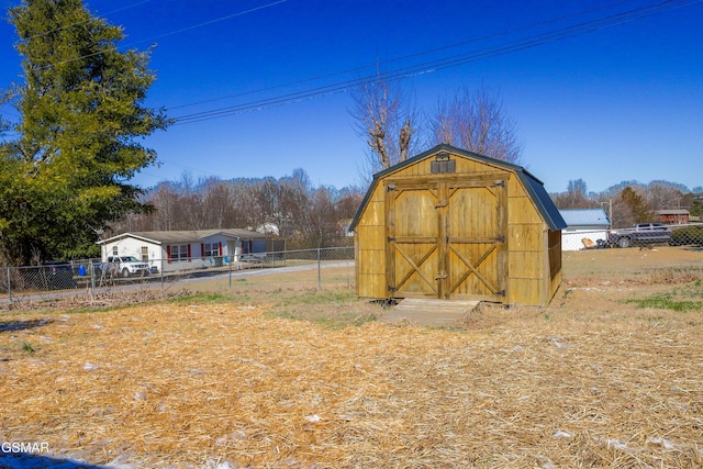 view of shed featuring fence