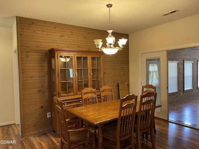3351 Line Springs Rd, Sevierville, TN 37862 - dining space featuring wooden walls, a chandelier, and dark wood-type flooring