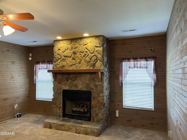 3351 Line Springs Rd, Sevierville, TN 37862 - unfurnished living room featuring carpet flooring, wooden walls, a ceiling fan, a fireplace, and plenty of natural light