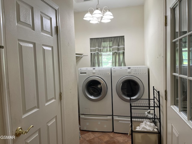 3351 Line Springs Rd, Sevierville, TN 37862 - laundry area with washing machine and clothes dryer, a chandelier, and healthy amount of natural light