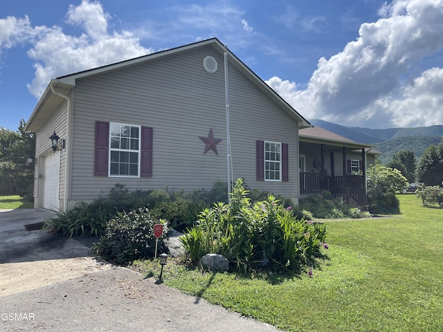 3351 Line Springs Rd, Sevierville, TN 37862 - view of property exterior with a lawn, covered porch, concrete driveway, a garage, and a mountain view