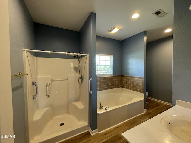 3351 Line Springs Rd, Sevierville, TN 37862 - full bath with wood finished floors, a stall shower, a jetted tub, vanity, and recessed lighting