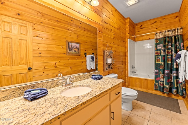 full bathroom featuring wood walls, tile patterned flooring, vanity, toilet, and shower / bath combo