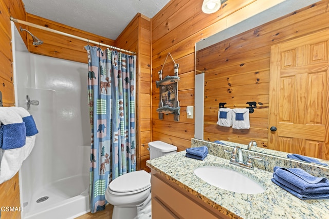 bathroom featuring vanity, walk in shower, a textured ceiling, and wood walls