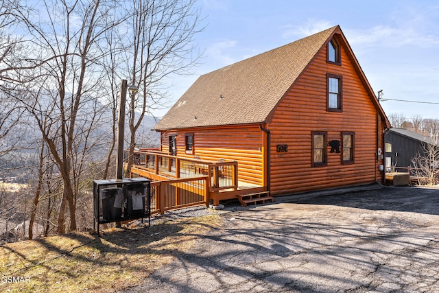 rear view of property with a wooden deck