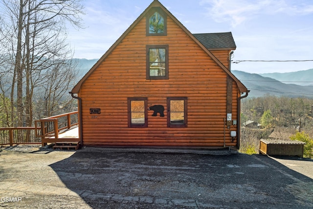 view of home's exterior featuring a deck with mountain view