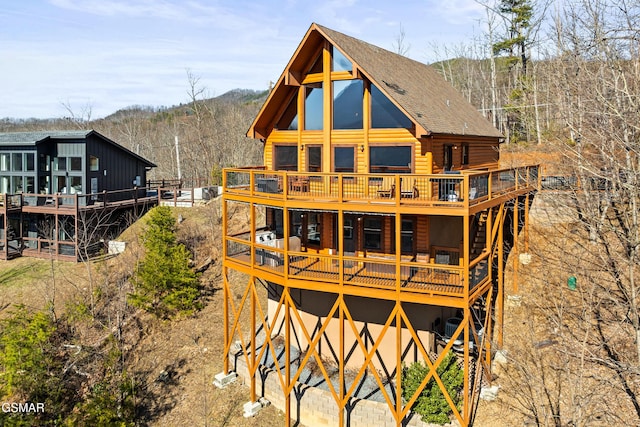 rear view of house with a wooden deck