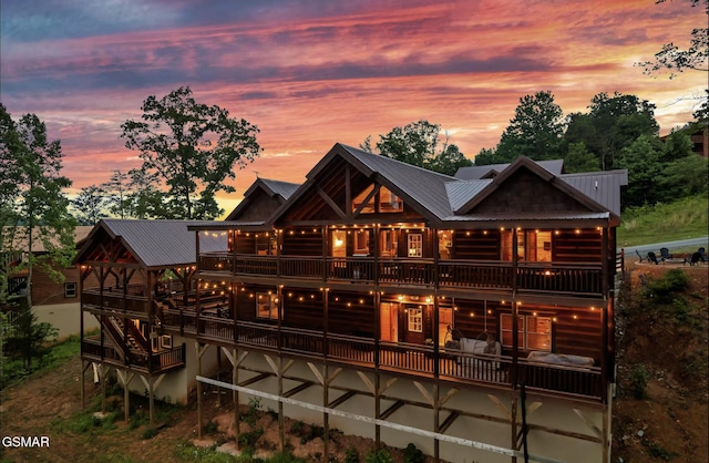 rear view of property with log veneer siding and metal roof