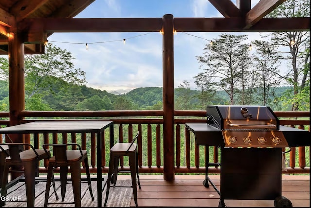 wooden deck featuring a grill