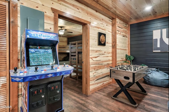 recreation room with wood walls, wood ceiling, ceiling fan, and wood finished floors