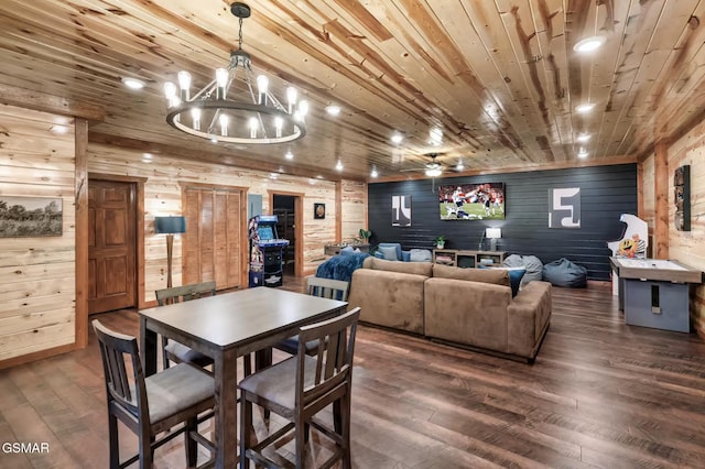 dining room with wood ceiling, dark wood-style floors, and wood walls