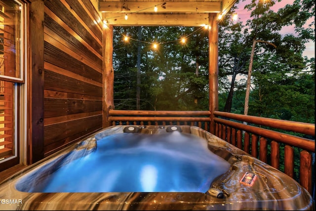 deck at dusk with an indoor hot tub