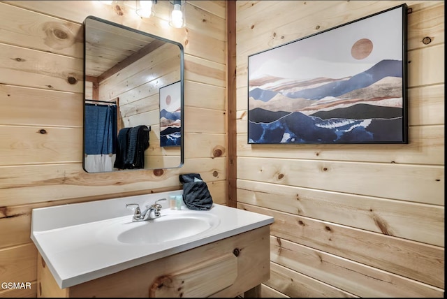 bathroom with vanity and wood walls