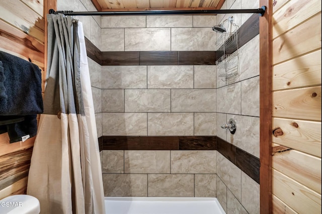 bathroom featuring a shower stall and toilet