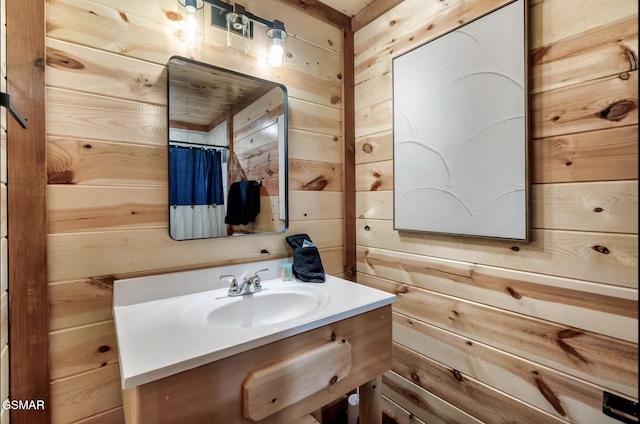 bathroom with vanity and wooden walls