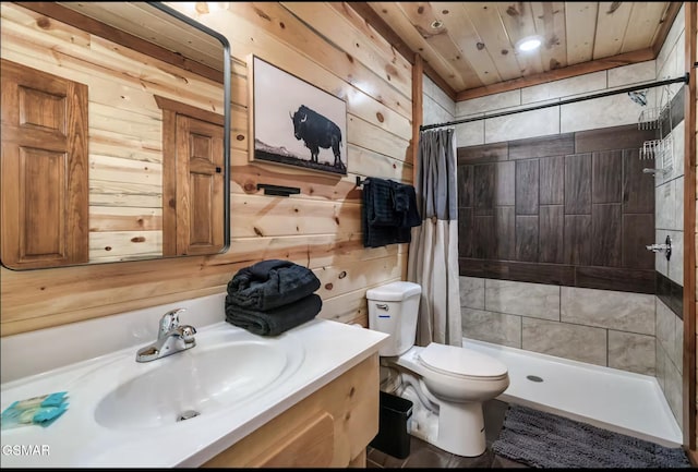 bathroom featuring wooden walls, toilet, tiled shower, and vanity