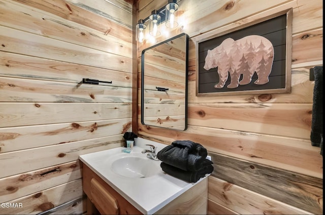 bathroom featuring wood walls and vanity