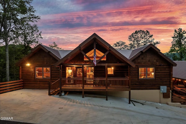 log home featuring metal roof