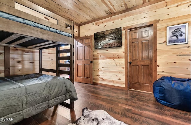 bedroom featuring wooden walls, wood ceiling, and wood finished floors