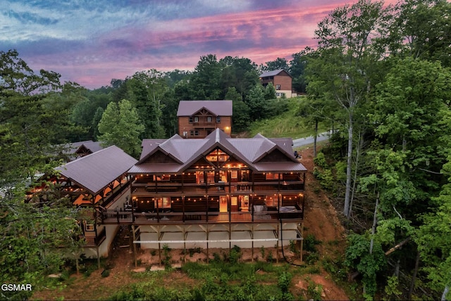 back of house at dusk with metal roof