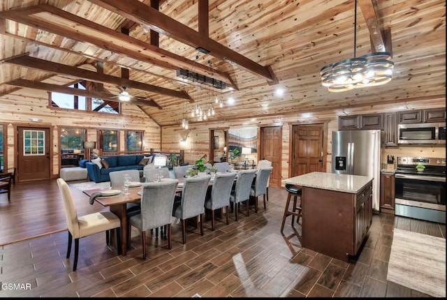 dining space with beam ceiling, wooden ceiling, and wood tiled floor