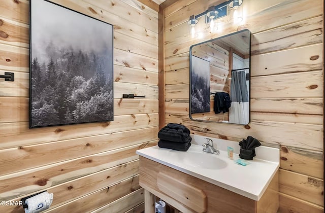 bathroom with vanity and wood walls