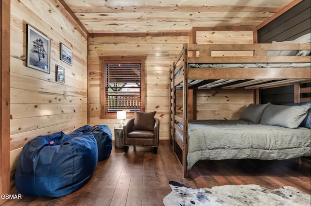 bedroom with wood walls, wooden ceiling, and hardwood / wood-style flooring