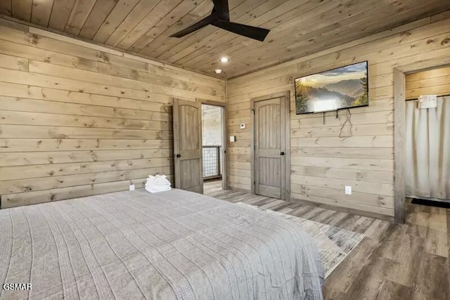 bedroom with wooden ceiling, wood finished floors, wood walls, and a ceiling fan