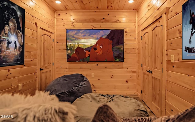 bedroom with wood ceiling and wooden walls