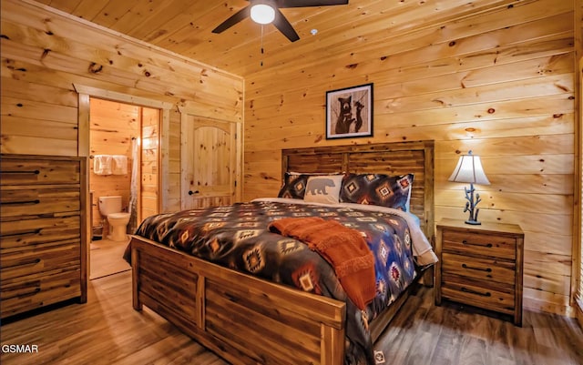 bedroom featuring ensuite bathroom, wood walls, wooden ceiling, ceiling fan, and hardwood / wood-style floors