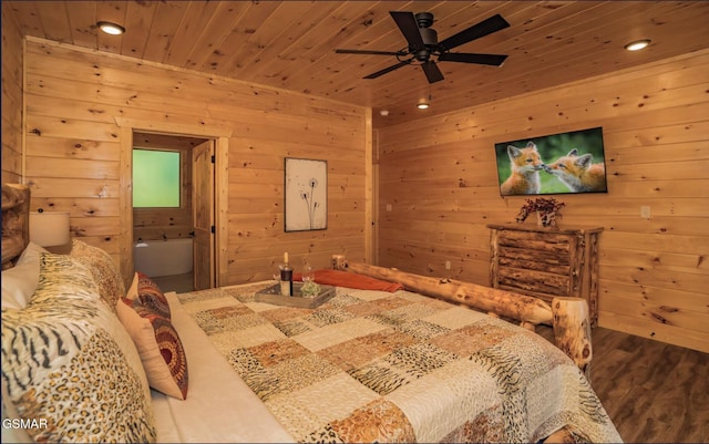 bedroom featuring wood ceiling, ceiling fan, hardwood / wood-style floors, ensuite bathroom, and wood walls