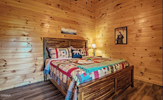 bedroom featuring dark hardwood / wood-style flooring and wood walls