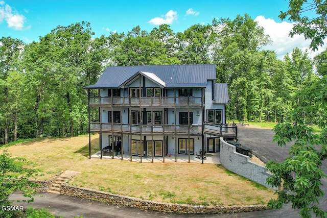 rear view of property featuring a yard and a patio