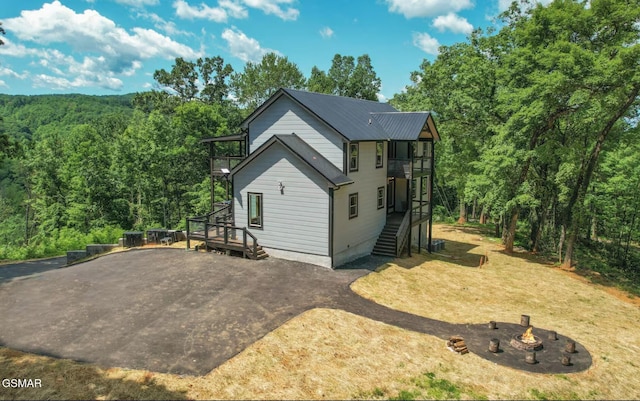 view of property exterior featuring a fire pit