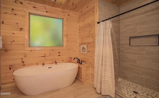 bathroom with tile patterned floors, wooden walls, separate shower and tub, and wooden ceiling