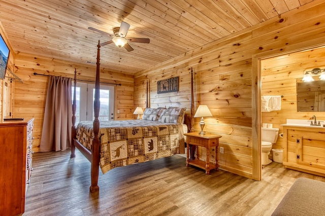 bedroom with hardwood / wood-style flooring, ceiling fan, wooden ceiling, and ensuite bath