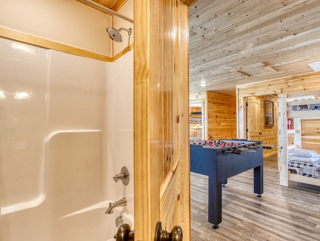 game room with hardwood / wood-style flooring, wood ceiling, and wood walls