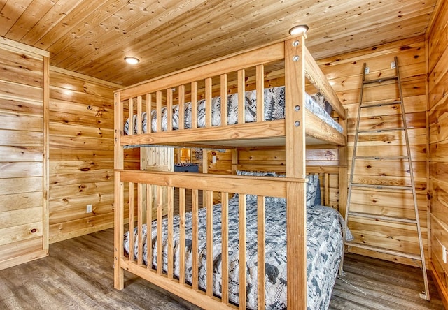 bedroom featuring hardwood / wood-style flooring, wooden ceiling, and wood walls