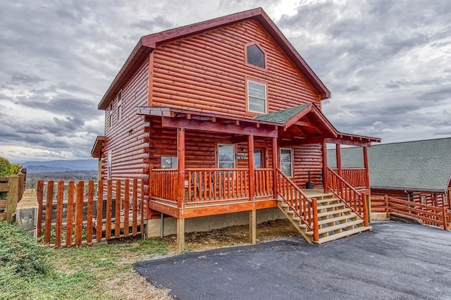 log home with a mountain view and covered porch