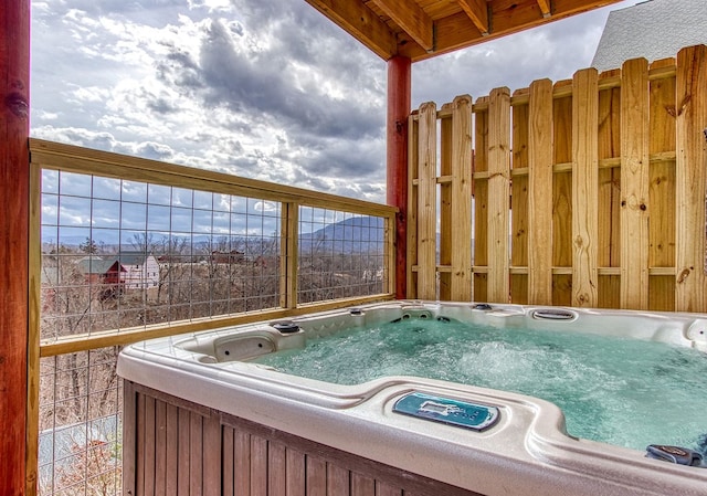 view of swimming pool featuring a hot tub