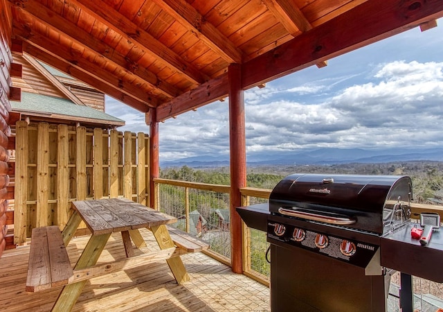 wooden terrace featuring a mountain view and a grill