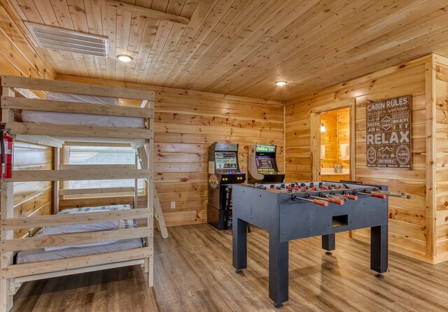 game room featuring hardwood / wood-style flooring, wood walls, and wooden ceiling